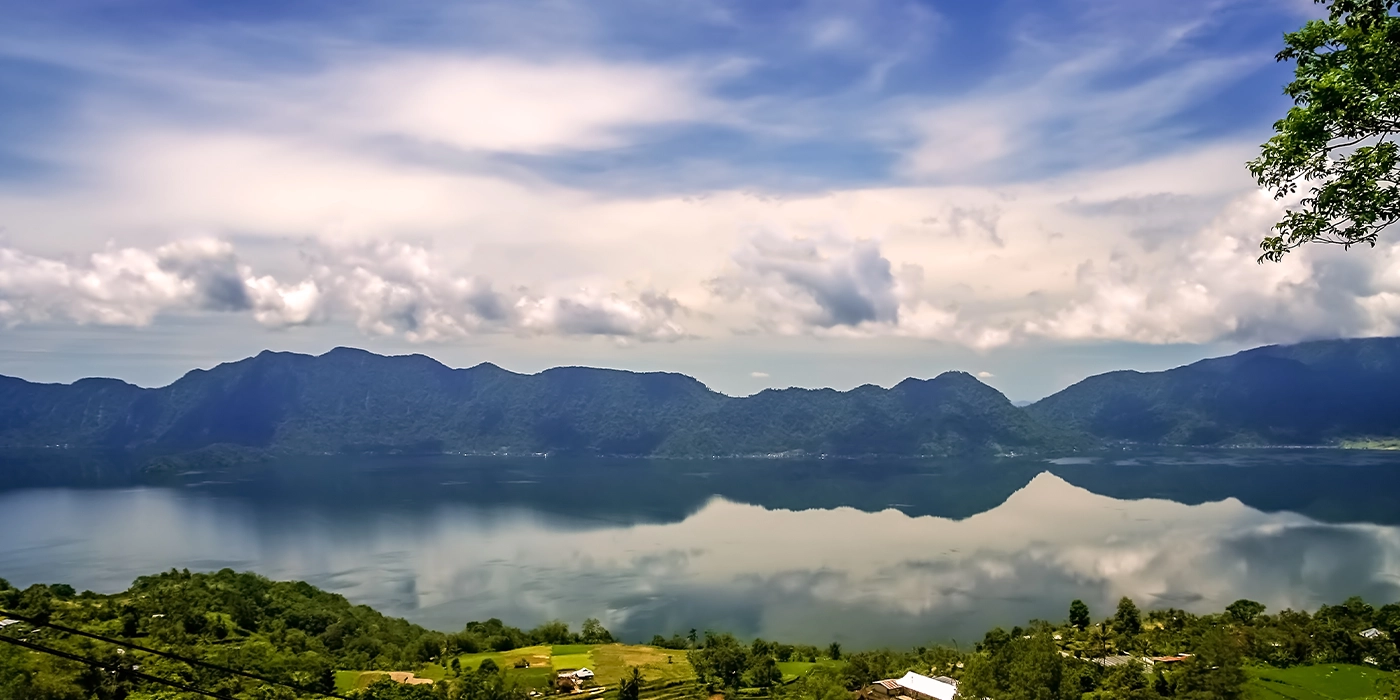 Lake Toba panoramic view surrounded by volcanic mountains in North Sumatra