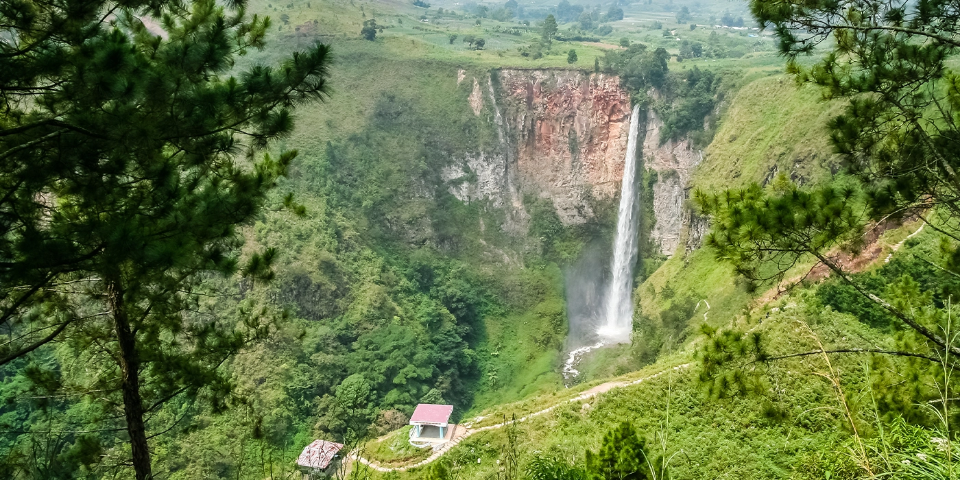 Sipiso-piso Waterfall surrounded by lush rainforest in North Sumatra